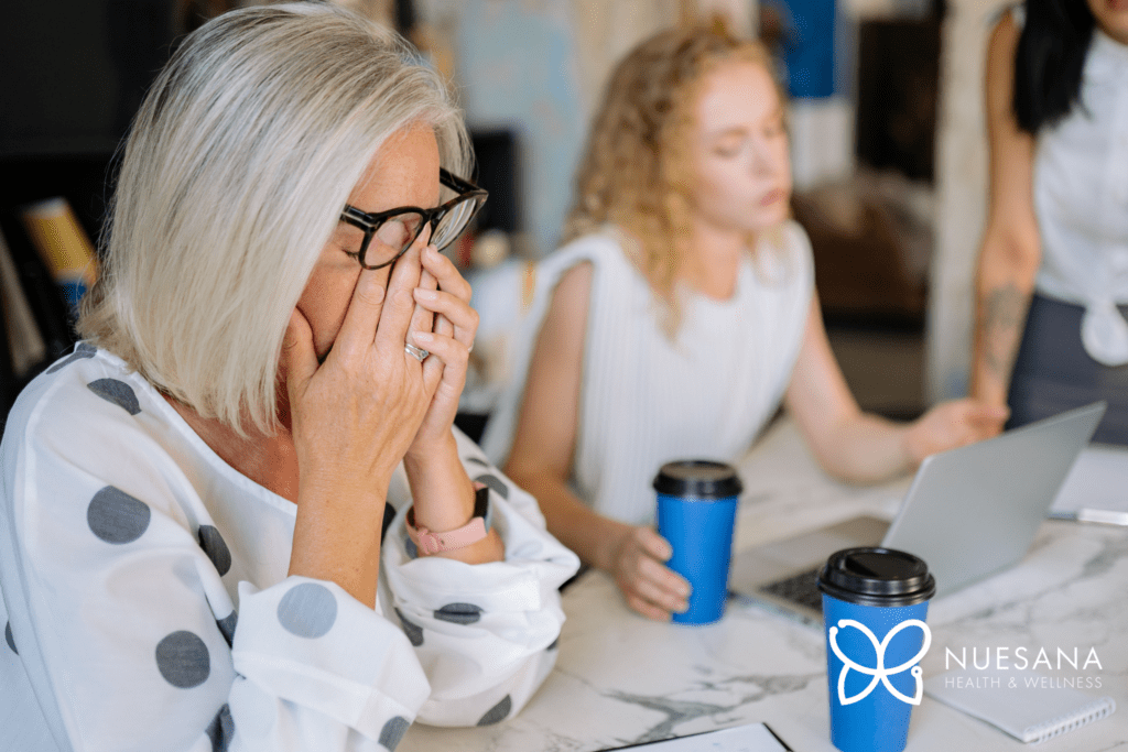Tired woman rubbing her eyes