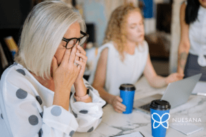 Tired woman rubbing her eyes